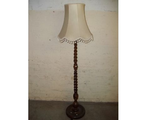 A SOLID WOOD BARLEY TWIST FLOOR STANDING LAMP
