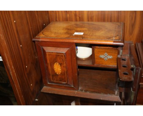 AN EDWARDIAN WALNUT SMOKERS CABINET WITH INLAID SATINWOOD DECORATION, the twin doors and hinged lid opening to a part fitted 