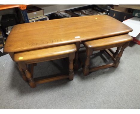 AN ERCOL OAK NEST OF TABLES 