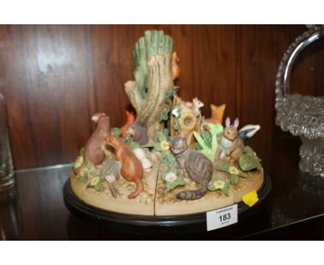 A REVOLVING CERAMIC R. HERSEY 'WOODLAND LIFE' FIGURE GROUP BY DANBURY MINT  