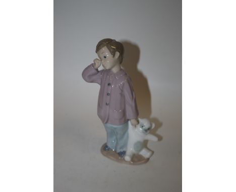 A NAO FIGURE OF A SMALL BOY WITH TEDDY BEAR 