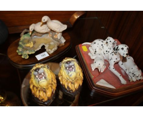 A PAIR OF REGENCY CERAMIC LION WALL HANGING MASKS TOGETHER WITH A  DALMATIAN ORNAMENT ON PLINTH AND ANOTHER (4) 