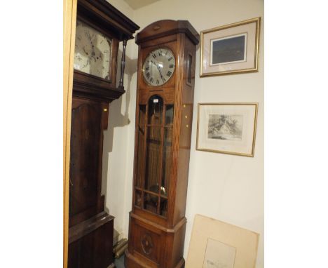 AN EARLY 20TH CENTURY OAK GLAZED LONGCASE CLOCK, the silvered dial with Roman numerals, the case with bevelled glass panels a