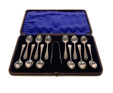 CASED SET OF TWELVE EARLY 20TH CENTURY SILVER SPOONS AND TONGS, Sheffield marks, each bright cut with foliage, the spoons 12c