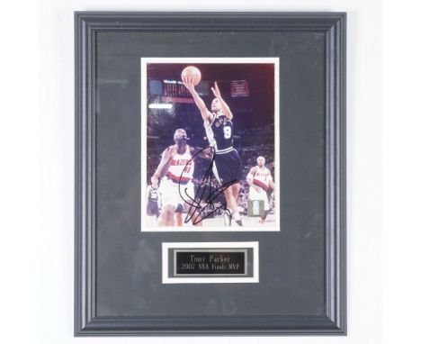 This autographed and framed NBA action photo captures Tony Parker (#9) of the San Antonio Spurs in a dynamic moment, driving 
