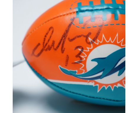 A Miami Dolphins mini football autographed by Hall of Fame quarterback Dan Marino (#13). This officially licensed NFL rubberi