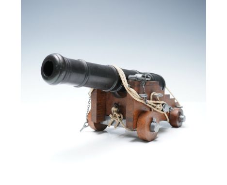 A finely detailed naval deck cannon model, reminiscent of the artillery used aboard historic warships. This beautifully craft