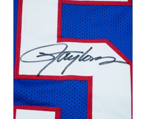 This New York Giants blue jersey is autographed by Hall of Fame linebacker Lawrence Taylor. Featuring Taylorâ€™s name and ico