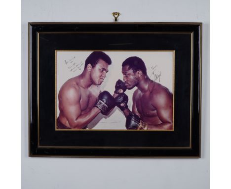A framed and autographed photograph featuring Muhammad Ali and Joe Frazier, two of boxingâ€™s most iconic champions, engaged 