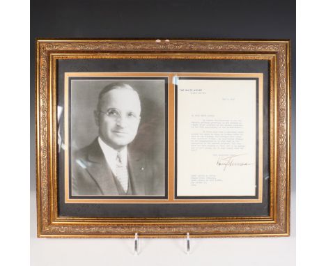 Framed display featuring a typed letter signed by President Harry S. Truman alongside a portrait photograph. The letter, date