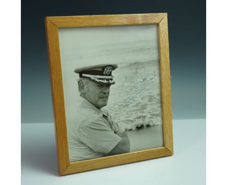 A historically significant signed photograph of Commander Lloyd M. Bucher, the commanding officer of the USS Pueblo, which wa