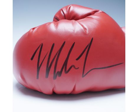 Presented is a red Everlast boxing glove, personally signed by former heavyweight boxing champion Mike Tyson. This high-quali