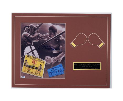 A memorabilia display featuring an autographed photo of Ken Norton from his historic 1973 heavyweight bout against Muhammad A