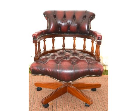 20th century captain's chair, button back faux leather seat and backrest, on swivel base with castors.      