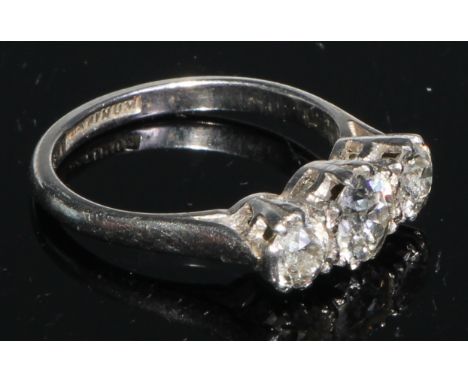 A three stone diamond ring, brilliant cut stones, platinum shank, size K/L 