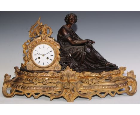 A late 19th century French gilt and bronzed metal figural mantel clock, 9.5cm circular enamel dial, Roman numerals, twin wind