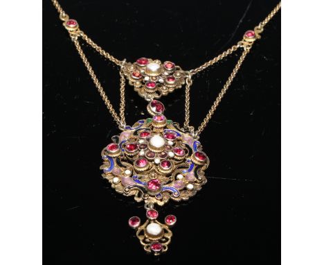 A Baroque style pendant, set with semi precious stones and pearls on a scrolling openwork enamel ground, interlinked chains, 