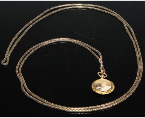 An Edwardian gold coloured metal snake link muff chain, lobster claw clasp, tests as 9ct gold, 80cm long, 37g; an Edwardian e