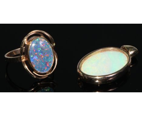 A 9ct gold black opal oval cabochon ring, collar set within open shank, stamped 375, size P, 3.6g gross;  yellow metal mounte