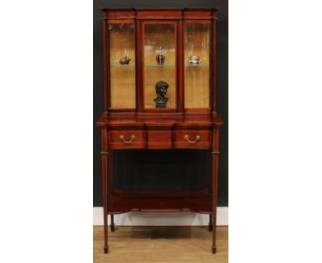 An Edwardian satinwood crossbanded mahogany pier display cabinet, outswept cornice above a glazed rectangular door enclosing 