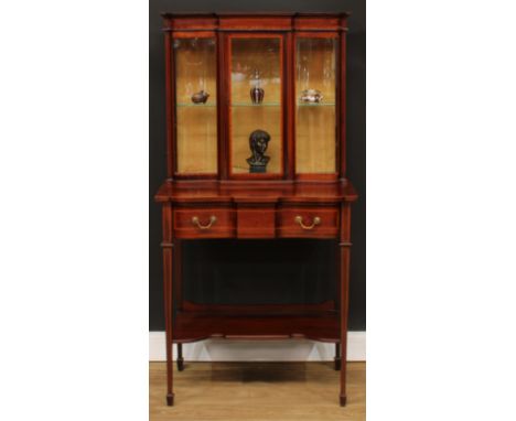 An Edwardian satinwood crossbanded mahogany pier display cabinet, outswept cornice above a glazed rectangular door enclosing 