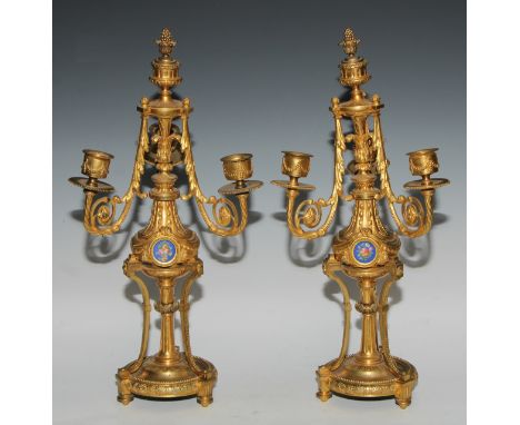 A pair of 19th century French porcelain mounted gilt metal three-light candelabra, in the Louis XVI taste, cast throughout wi