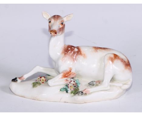 A Derby patch mark model, of a doe, the shaped base applied with flowering boccage, 16cm long, c.1770 