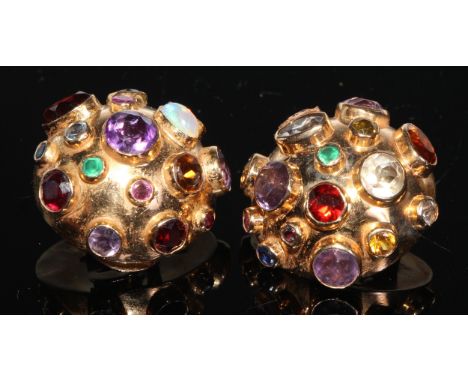 A pair of multi-gem clip on earrings, the domed body inset with oval and round cabochon and facet cut stone including emerald