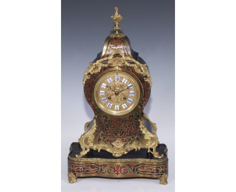 A 19th century French boulle cartouche shaped mantel clock, 10cm circular dial inscribed with Roman numerals upon shaped rese