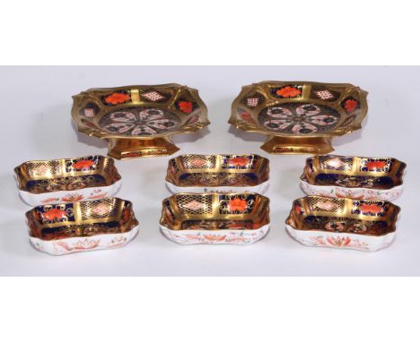 A pair of Royal Crown Derby 1128 pattern shaped square pedestal comports, solid gold bands, 14cm wide, printed marks, first q