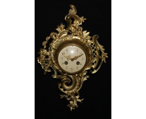 A late 19th century French gilt metal cartel clock, 8.5cm enamel dial inscribed with Arabic numerals, twin winding holes, eig