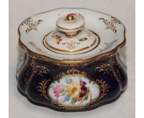 A Meissen lobed circular inkwell and cover, decorated with reserves of summer flowers, picked out in gilt on a cobalt blue gr