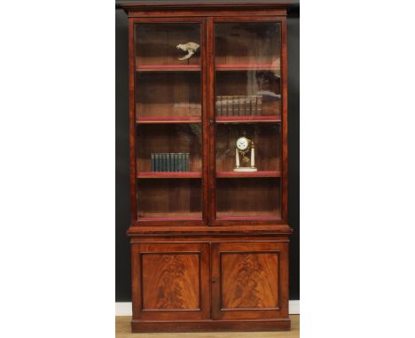 A 19th century mahogany library bookcase, outswept cornice above a pair of glazed doors enclosing adjustable shelves, the pro