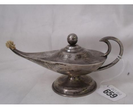 A table lighter in a form of an oil lamp 6” long marked  sterling         