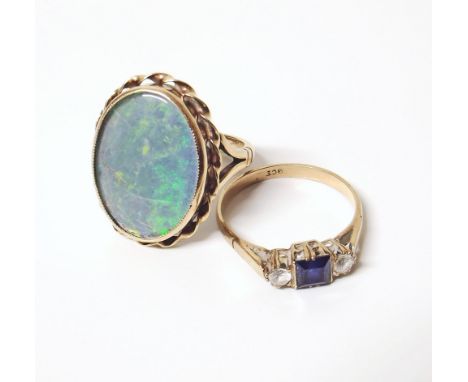 Two 9ct gold dress rings, one set with blue and white stones, one with opal simulant Conditions reports are not available for