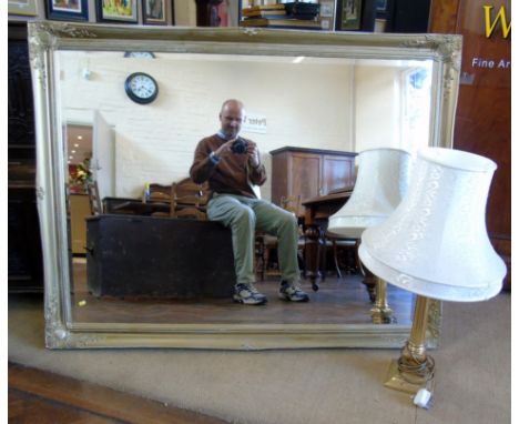 Modern brass Corinthian column table lamp and gilt framed wall mirror. Conditions reports are not available for our Interiors