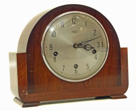 20th century mahogany mantel clock, three-train movement striking on Westminster chime. Conditions reports are not available 