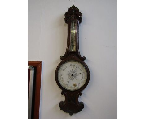 An oak wheel barometer, glass cracked and temp stick broken