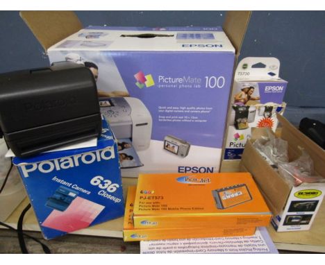 Polaroid instant camera with box and a Epson picture mate photo lab with accessories in box