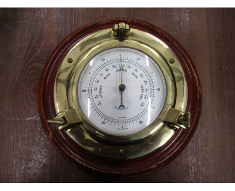 A brass and wood barometer