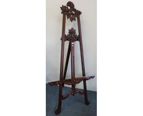 A modern carved mahogany floor standing picture display easel, 184cm high