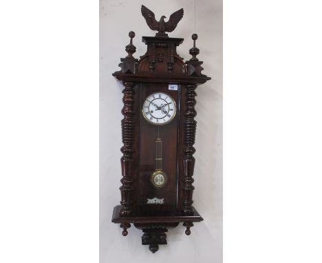 Early C20th continental walnut cased Vienna style wall clock, pediment crested with eagle and turned finials, fully glazed pa