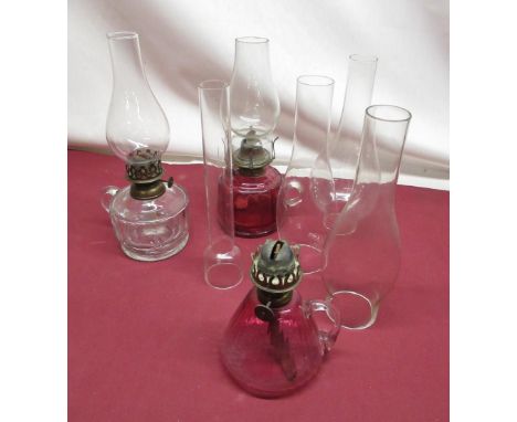 Late C19th handheld oil lamp with cranberry tinted reservoir, H28cm, similar handheld lamp lacking shade, late C19th handheld