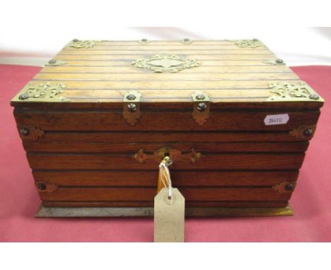 Late Victorian Gothic revival oak cased and brass bound games compendium, with engraved fretwork brass cartouche, carrying ha