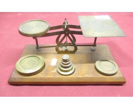 C20th lacquered brass postage scales, on oak base with weights, W26cm D15cm H10cm 