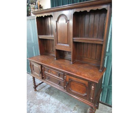 C20th oak dresser, shelved panel back above two drawers and two doors, on bobbin turned legs with stretchers, W155 D48cm H185