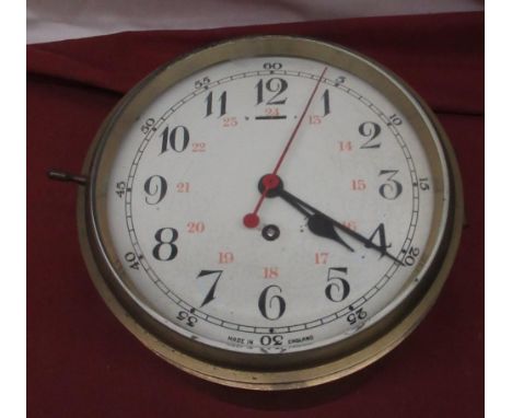 C20th brass bulkhead type clock, circular white Arabic dial with red 24hr numerals and seconds sweep, black hours and five mi