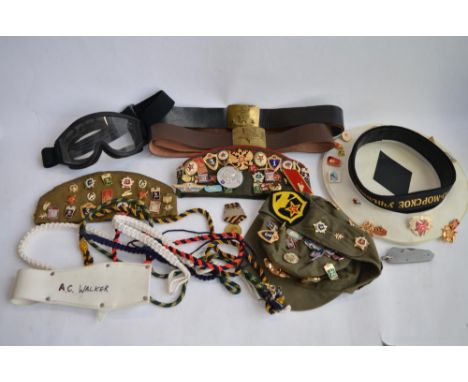 A collection of mostly Russian caps with a large number of badges attached, many naval and parachute related. Also a WWII Rus