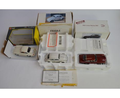 3 boxed 1/24 scale die-cast european car models:A Danbury Mint 1964 Aston Martin DB5, box fair, no paperwork. Model excellent