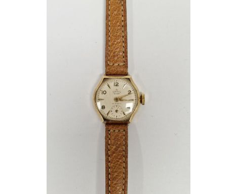 Vintage Smiths de luxe 9ct gold cased lady's wristwatch, the circular dial having alternating gilt Arabic and arrow hour mark